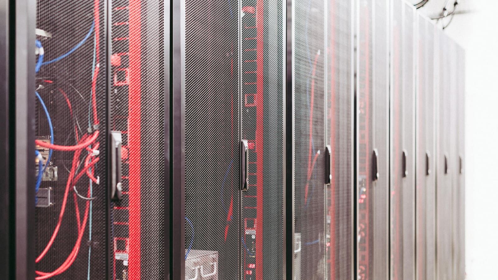 Rows of data-center server racks with network cabling